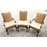 A set of fourteen 18th century style mahogany framed studded tan leather upholstered dining chairs