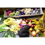 A box containing a collection of vintage velvet flower and other corsages,