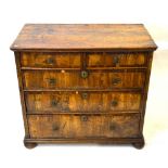 An early 18th century crossbanded walnut/fruitwood chest of two short over three long graduated