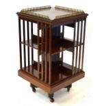 A good quality Victorian mahogany revolving bookcase having a gilt galleried top over two tiers