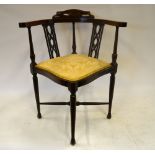 Edwardian walnut corner chair with fret-cut splats over a cushioned seat raised on slender turned