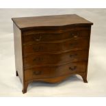 A Georgian style mahogany serpentine chest of four long graduated drawers beneath a brush slide,