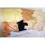 Two peach silk and a black silk nightgowns, an ivory silk nightshirt, a cream rayon nightgown,