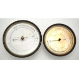 A 19th century aneroid barometer, the silvered dial with carved mercury thermometer,