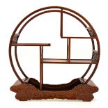 A Japanese hardwood table stand, the open circular frame (sun or moon) raised on a cloud form base,