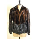 A black leather and dark brown mink bomber-style lady's jacket retailed by Giddings Furs, Harrow,
