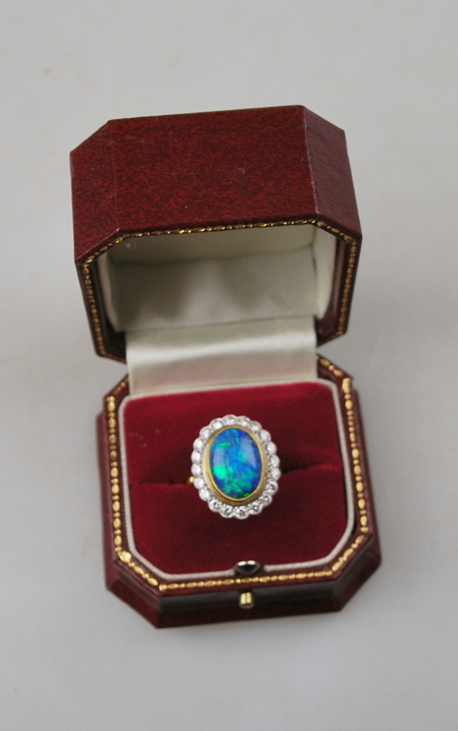 An oval black opal ring having brilliant cut diamonds around, in open basket style setting, - Image 3 of 4