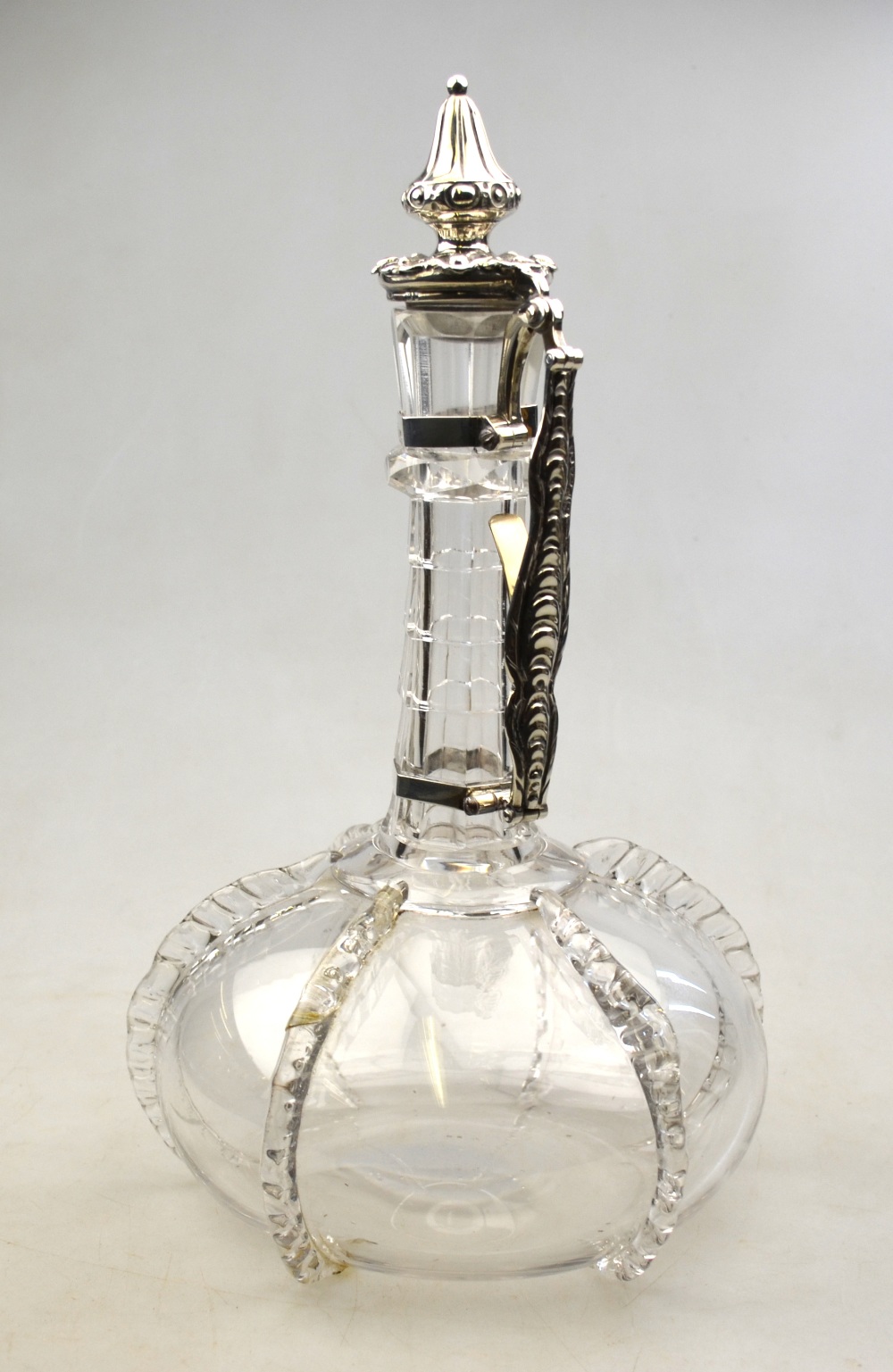 A Victorian blown glass claret jug of onion form with hexagonal cut neck and applied pinched