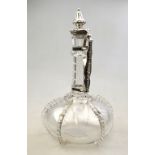 A Victorian blown glass claret jug of onion form with hexagonal cut neck and applied pinched