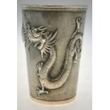 A Chinese silver beaker of tapering form embossed and chased with dragons guarding a flaming peach,