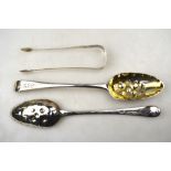 A pair of silver berry spoons of Georgian origin, with engraved stems and embossed gilt bowls,