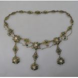 An Austro-Hungarian gilt metal necklace in fringe renaissance style set with green stones,