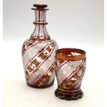 A Bohemian ruby flash glass night time water decanter and stopper with matching tumbler having