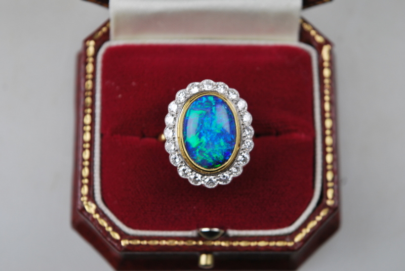 An oval black opal ring having brilliant cut diamonds around, in open basket style setting, - Image 4 of 4