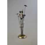 A silver hatpin stand and ring-tree with miniature ivory 'tusks' above stem set with four