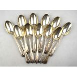 A set of eleven modified thread and shell pattern silver dessert spoons of small proportions,