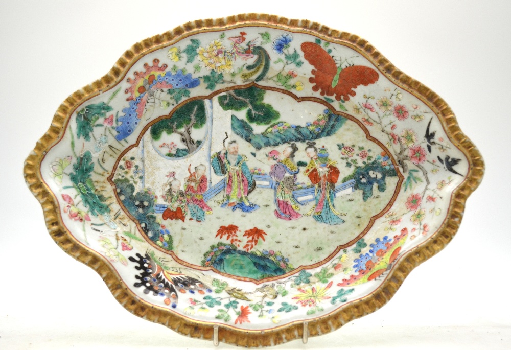 A Chinese Canton famille rose shaped dish decorated with figures in a garden,