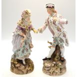 A pair of 19th century Rudolstadt Volkstedt figures of a lady and gentleman standing on a