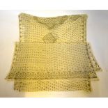 A 1920s cream Assuit shawl decorated with gold coloured hammered metal in geometric pattern,