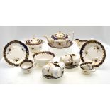 An early 19th century Ridgway part tea service having a cobalt blue band and blue floral sprigs and