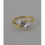 An old cut diamond and pearl crossover ring, 18ct yellow and white gold claw setting,