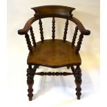 A late 19th /20th century bow elbow chair with bobbin turned frame