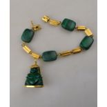 A Chinese style bracelet of square malachite beads interspersed with tubular unmarked yellow metal