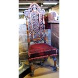 An antique carved oak Carolean style hall chair with overstuffed seat raised over a shaped