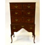 A diminutive cross-banded burr walnut chest on stand having two short over two long drawers and