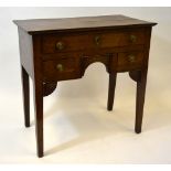 An 18th century oak low boy having a wide two plank top over three frieze drawers around a moulded