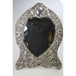 A large Victorian silver-faced easel toilet mirror with heart-shaped bevelled plate surmounted by