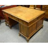 An antique mahogany pedestal partners desk,