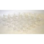 A part suite of heavy cut crystal drinking glasses including twelve champagne bowls and seven water