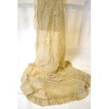 An ivory lace panel lined with organza and embellished with silvered beads (possibly ornate drape