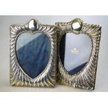 Two late Victorian photograph frames with embossed silver fronts and heart-shaped apertures,