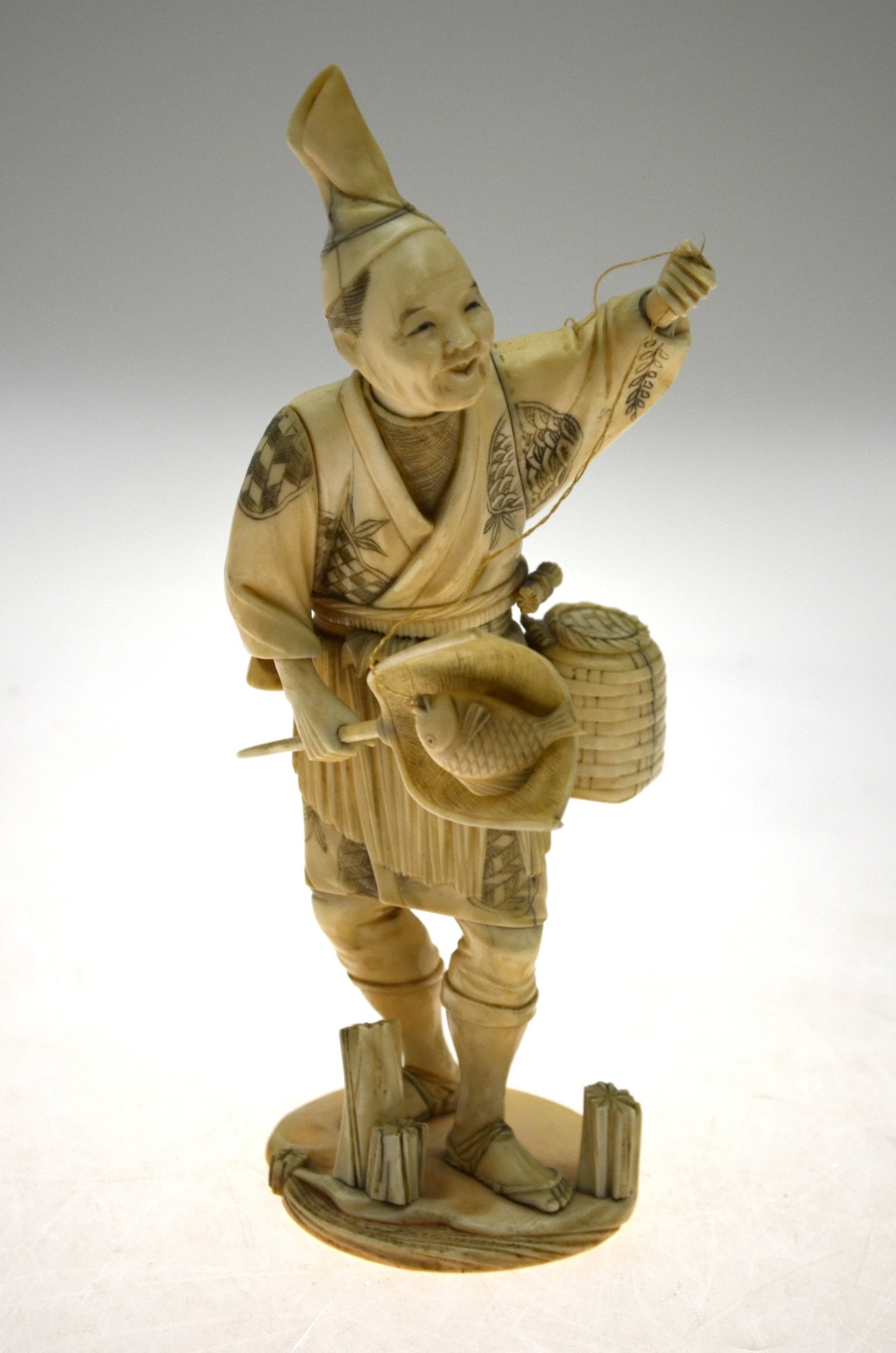 A Japanese Meiji period sectional carved ivory Okimono, fisherman with catching net (pole missing), - Image 4 of 5