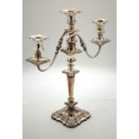 A plated on copper twin-branch candelabra with three sconces and foliate-embossed decoration,