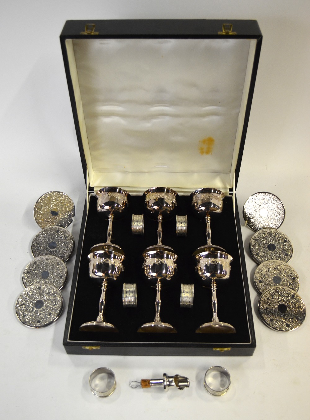 A Harrods cased set of six electroplated goblets with engraved vine decoration,