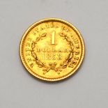 A US 1853 gold dollar