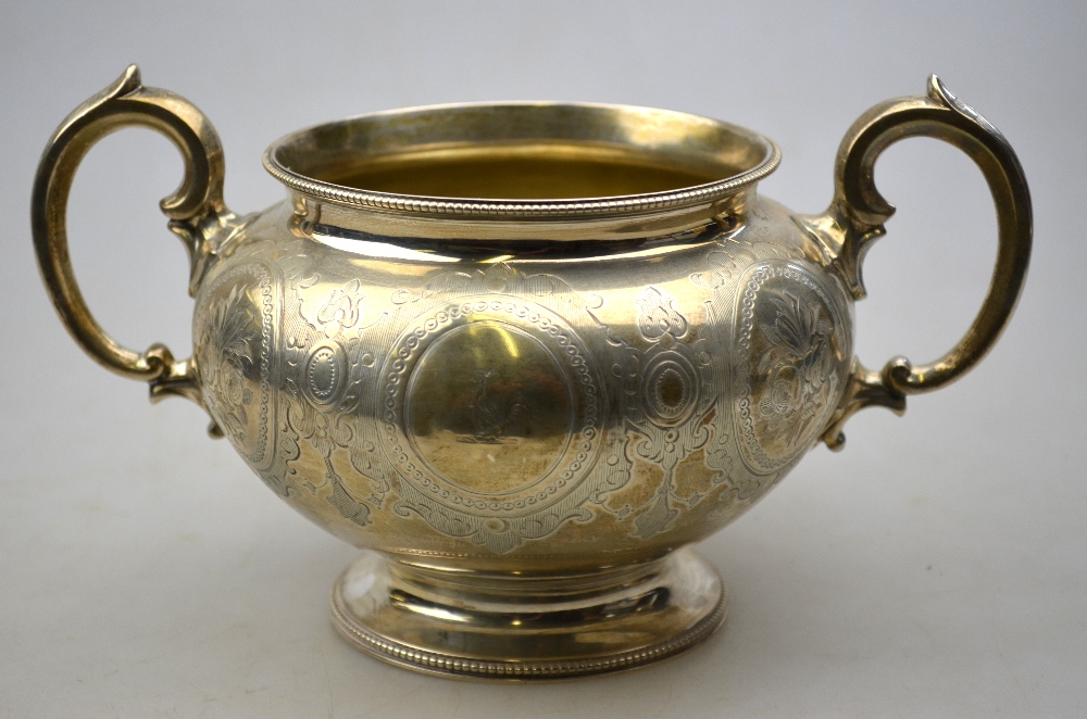 A Victorian engraved silver two-handled sugar basin with beaded rim and flared foot,