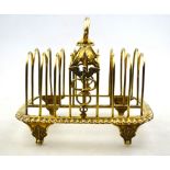 Medical interest: A George III silver gilt toast rack with oval beaded top ring handle flanked by