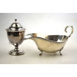 A late Victorian silver Adam revival urn-shaped caster with gadrooned rim and stemmed circular foot,