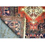 A contemporary Persian Hamadan rug, the geometric triple diamond design on pale red ground, 1.