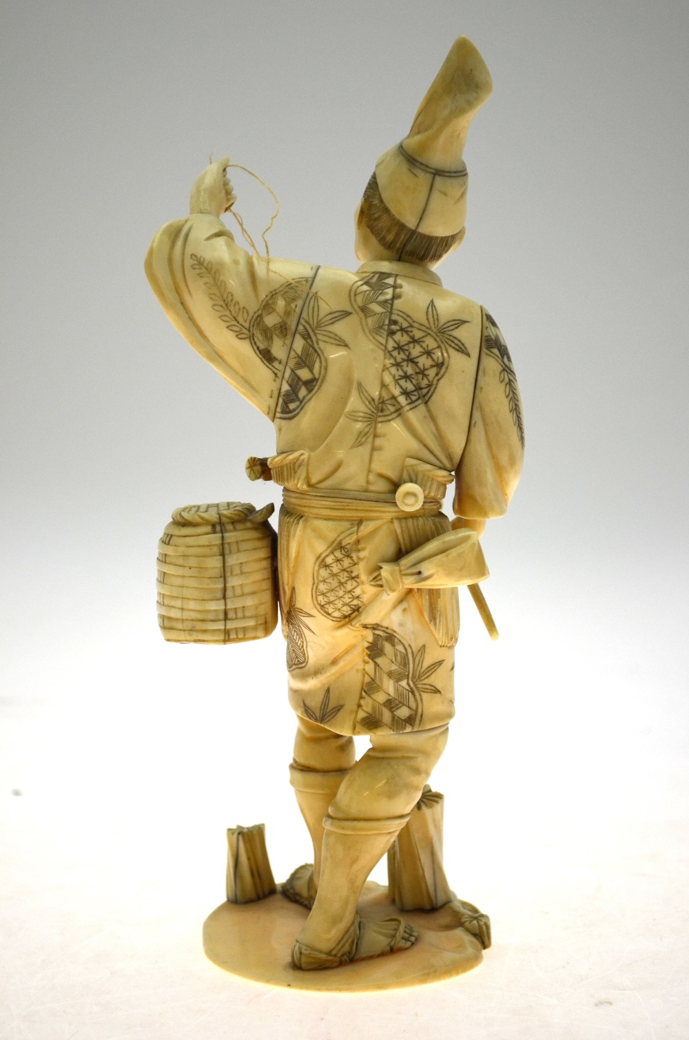 A Japanese Meiji period sectional carved ivory Okimono, fisherman with catching net (pole missing), - Image 5 of 5