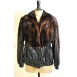 A black leather and dark brown mink bomb