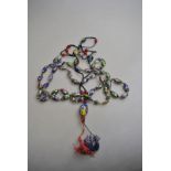 A long row of Venetian multi-coloured beads to/w Venetian beads on cord with tassel