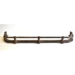A substantial 19th century polished steel bar fender raised on five well cast paw feet,