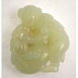 A Chinese jade carving of a small happy boy with duck and foliage,
