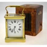 A brass carriage clock with repeating English movement striking on a coiled gong,