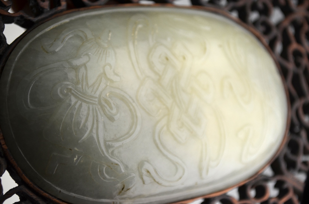 A Chinese oval pale jade plaque carved in shallow relief with auspicious objects (11. - Image 4 of 6